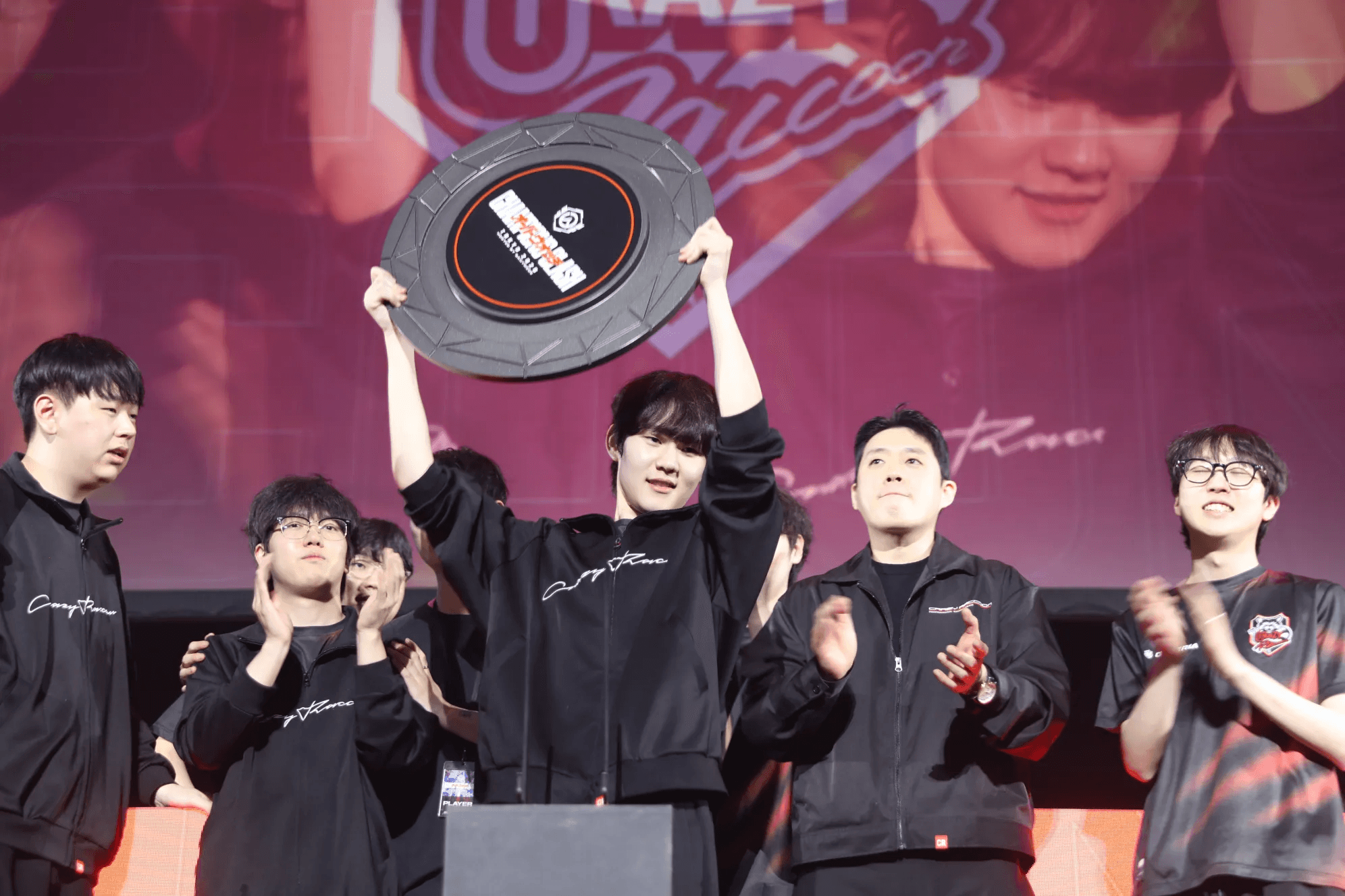 Crazy Raccoon lift the Champions Clash 2026 trophy. Photo by Blizzard Entertainment and GANYMEDE.